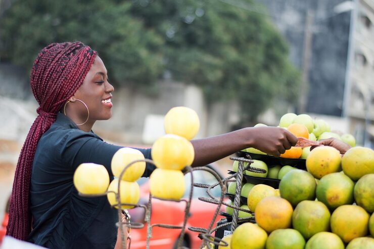 Young farmer holding fresh fruits