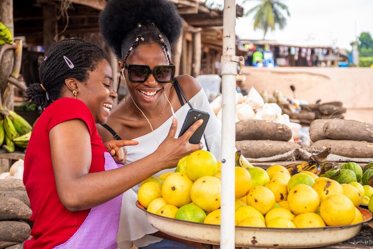 Field agent helping a farmer with a phone